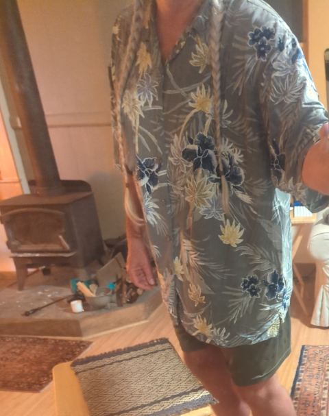 selfie of twoprops in an aloha shirt and shorts