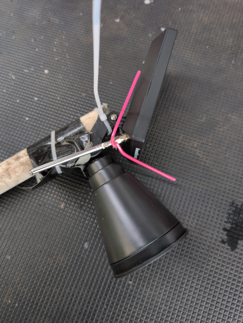 photo showing the antenna mounted to the solar autonomous node, pointing downward with the ground-plane radials pointing up