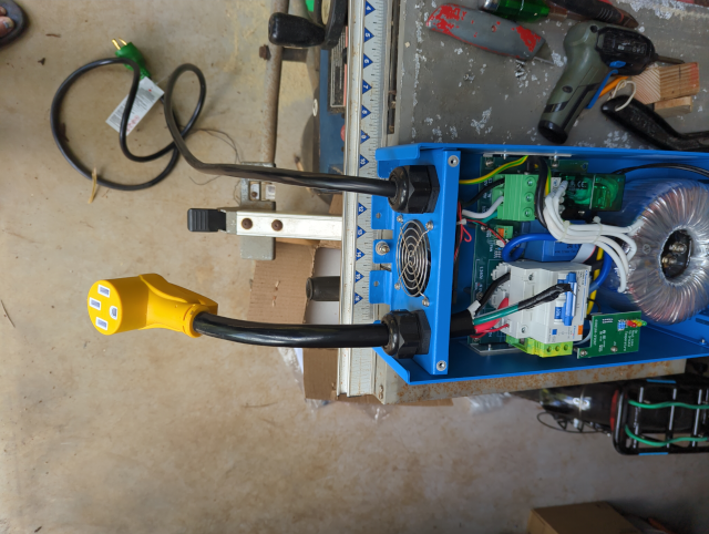 photo of the autotransformer with the cover removed and installing pigtails for the 120v generator side and the 220v house inverter side