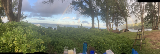 photo of a rainbow arcing across a bay