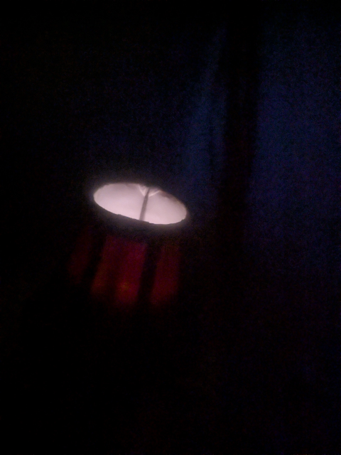 photo of the above lamp in darkness, and a faint glow can be seen coming from inside it