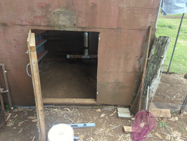 photo of the door into the chicken coop; it's a half-height wooden door