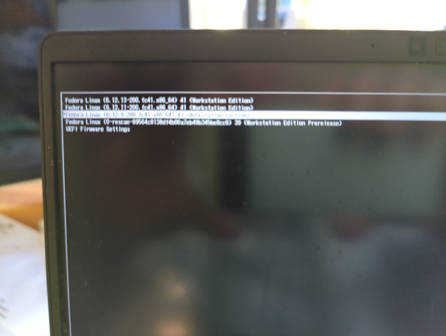 photograph of laptop screen at boot showing a selection of kernel versions