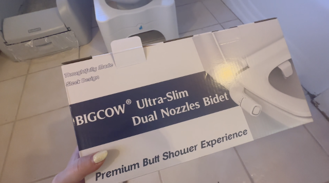 photograph of a box containing a bidet attachment and promising a "Premium Butt Shower Experience