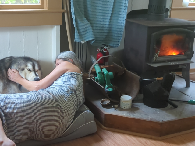 photo of HA and Luna the Big Dog™ by a roaring morning fire