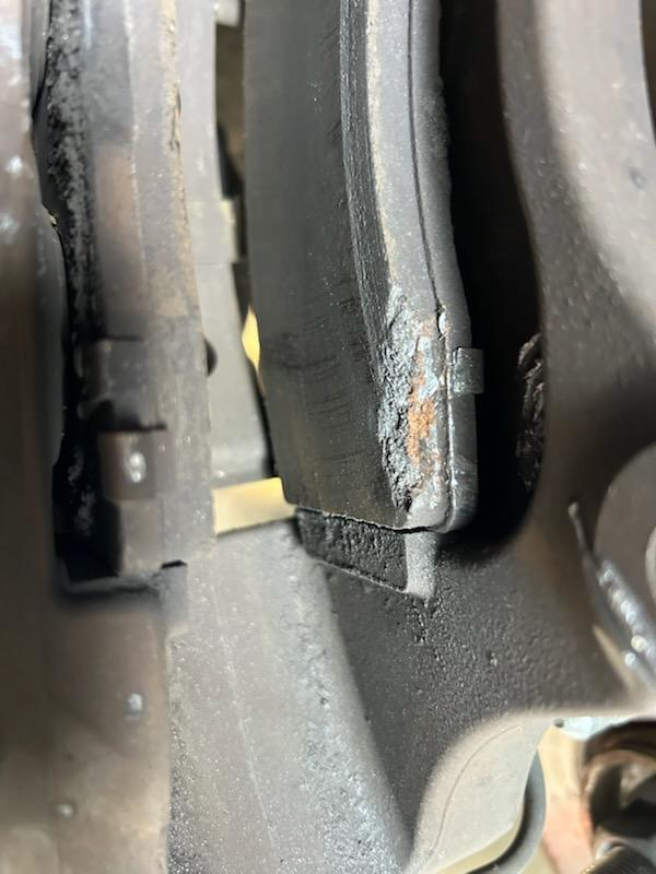 photo of the brake caliper and pad where the errant weight had lodged