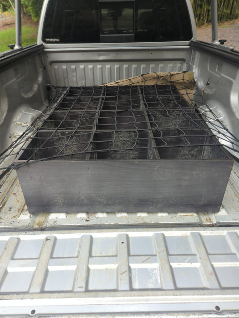 photo of the bed of Timmy the Titan with a cargo net deployed