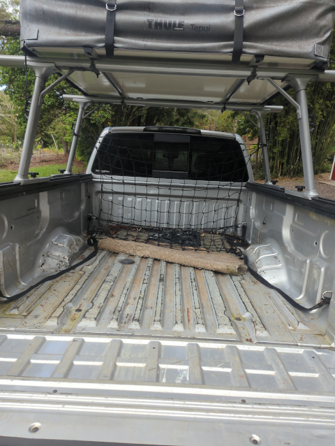 photo of the bed of our pickup truck with a cargo net hanging from the racks