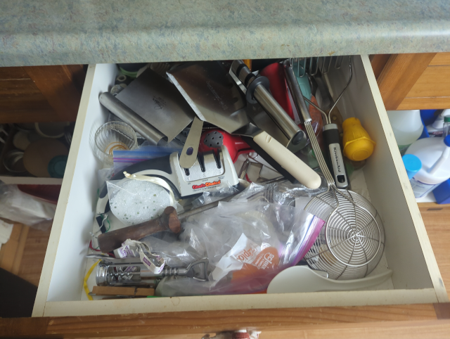 photo of a kitchen drawer with a hodgepodge of random kitchen tools
