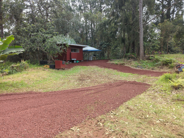photo of the cindered pad for a tent dining area, a path to the generators, and cinder forming a covered area around the front of the studio