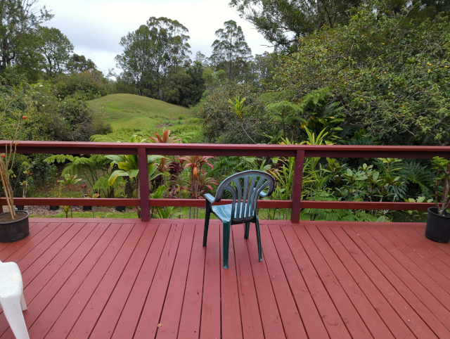 photograph of the view from our back deck, showing the rolling hills of our pasture and the sky/ocean horizon in the distance