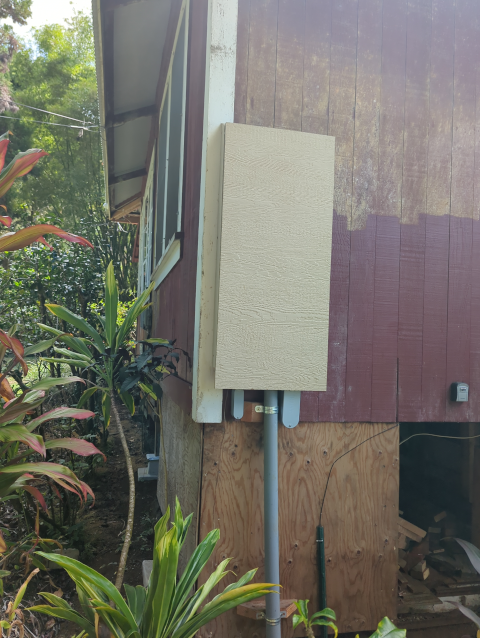 photo of a wooden box covering the electrical service panel at the house