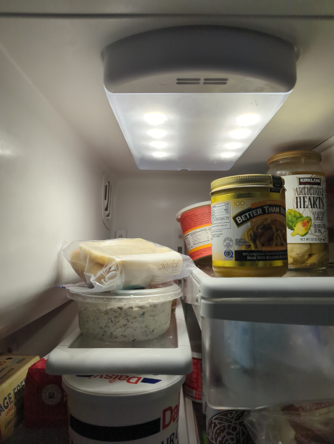 photo of the interior of our refrigerator showing a brightly glowing light assembly