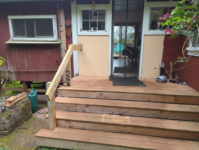 photo of our front steps with a new, unfinished handrail on the left side
