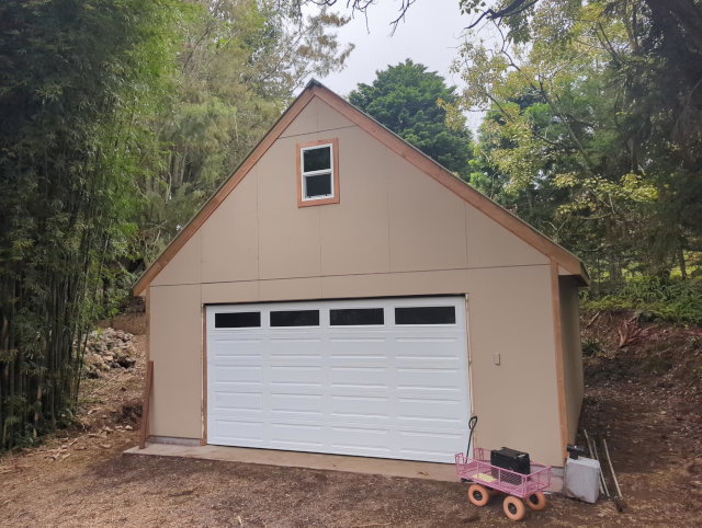 photograph of garage with the proper door sporting windows across the top