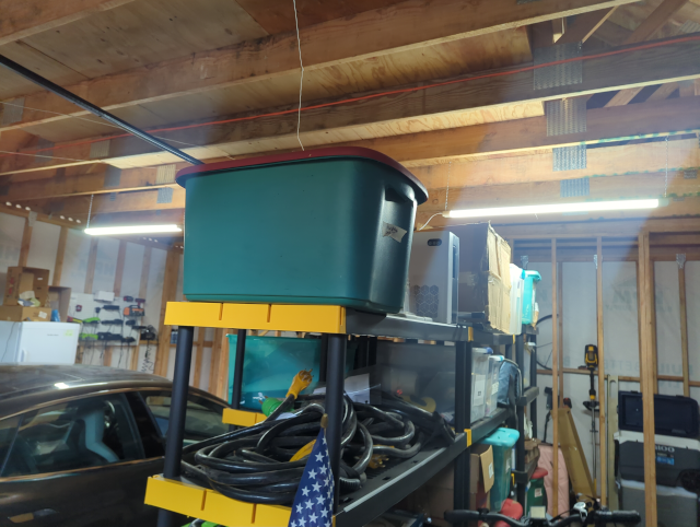 photo of the garage, with newly-installed pseudo-fluorescent LED shop lights hanging from the joists