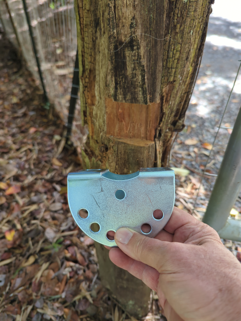 photo of an ‘ōhi’a gate post with a notch for the bracket that will hold the electric gate opener