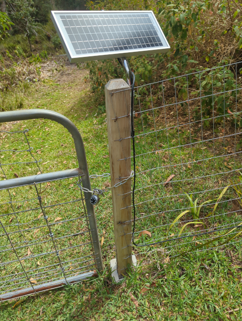 photo of the solar panel for the electric main gate, showing the cable neatly dressed down the mounting pole