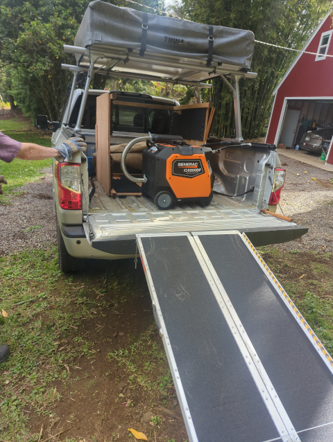 photo of the back of Timmy the Titan pickup truck with the generator and the generator house components loaded