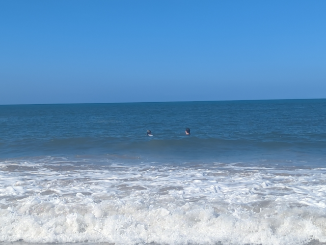 photo of HA and her son in the surf
