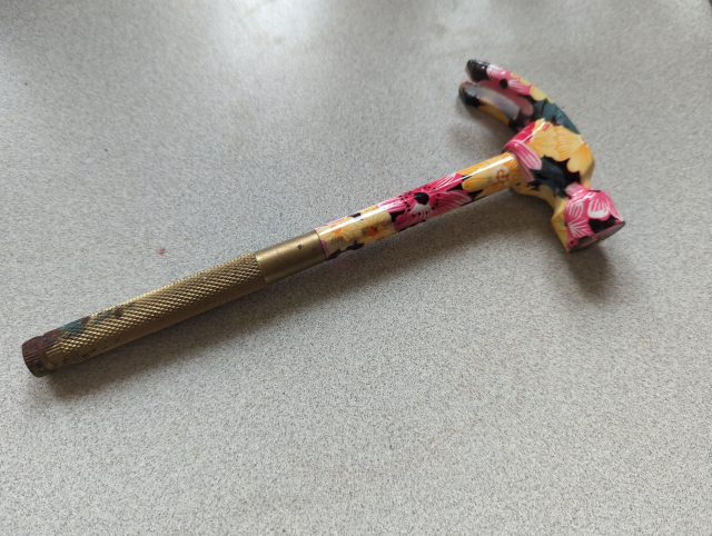 photo of a hammer with flowers painted on it