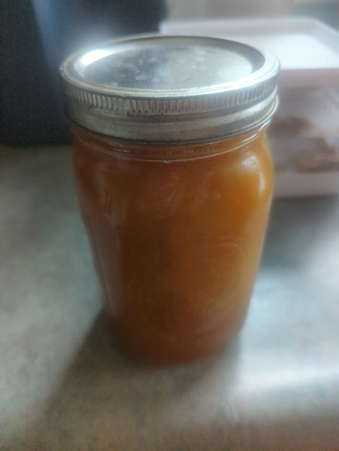 photo of a quart mason jar filled with opaque amber honey