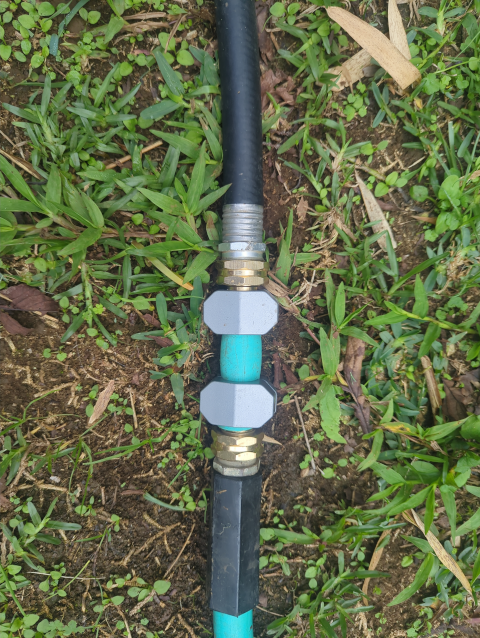 photo of two garden hoses connected together with a short coupler