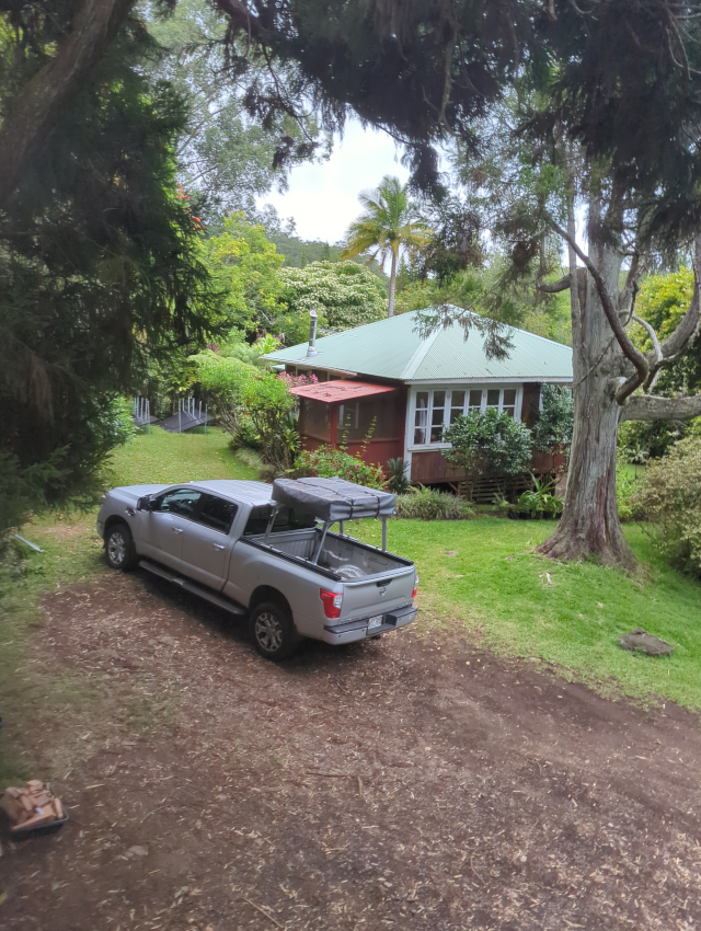 photograph looking down at the house from the front with Timmy the Titan in view