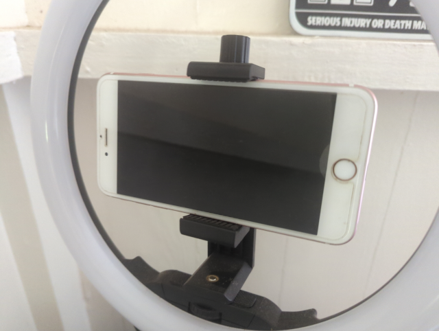 photo of an ancient iPhone 6s+ mounted in a ring light