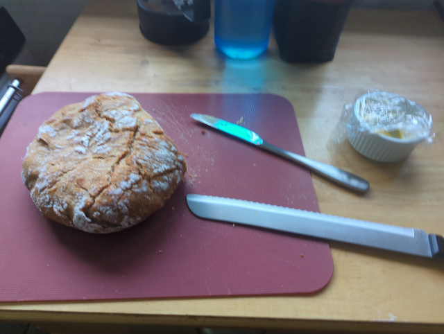 photo of a loaf of bread with a piece sliced off