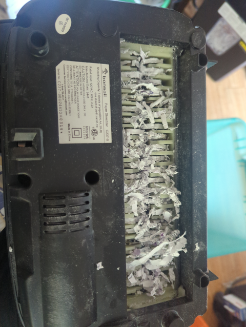photo of the inside of a crosscut paper shredder showing bits of paper jamming the cutters