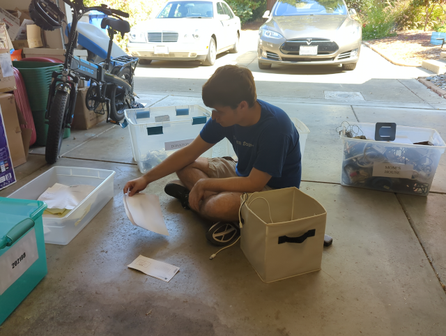 a picture of my youngest son on the garage floor sorting and packing