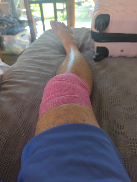 photo of my knee wrapped in pink horse tape