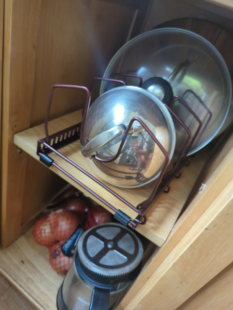 photo of the new lid rack, populated and placed in the lid cubby