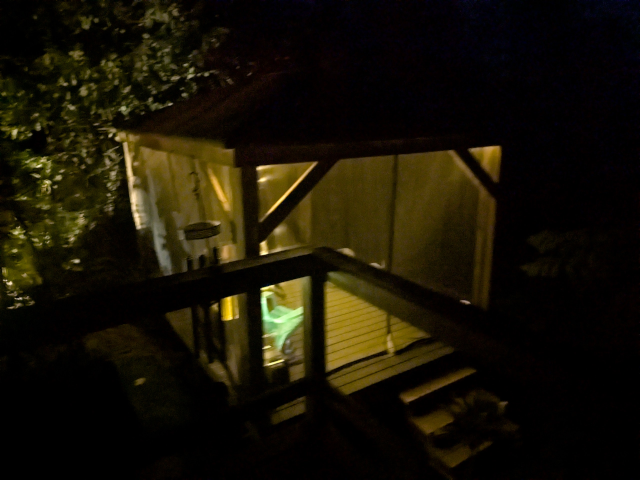 photo looking down on the pavilion at night with the lights on; the perspective hides the bulbs so the interior of the structure just seems to glow