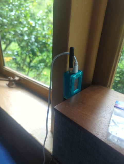 photo of a tiny LoRa node in a window