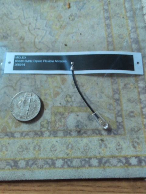 photo of a tiny dipole antenna next to a US nickel 5¢ piece