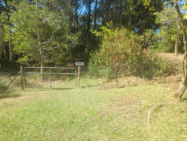 photo showing the solar panel for charging the gate, mounted next to a different gate that gets more sun