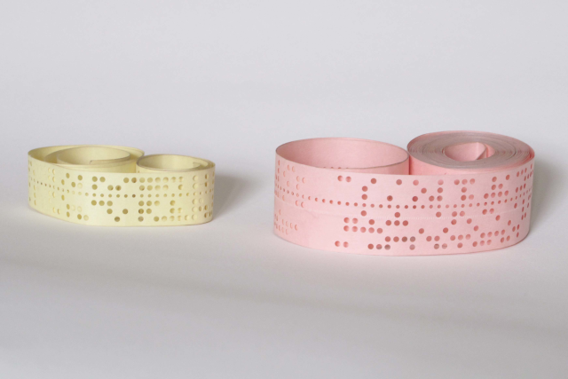 photograph of some short lengths of punched paper tape