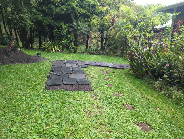 photo looking toward the front door from the driveway, showing three more ranks of paving stones on the walk