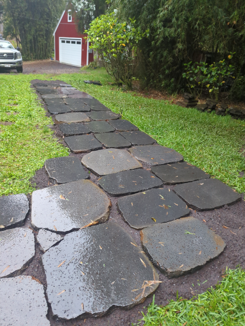 photo looking at the new path headed toward the driveway; four or five more ranks of stones have been laid but things are looking very wet