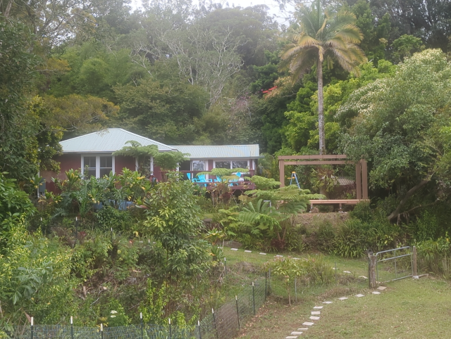 photo from the pasture, looking up at the back of the house with the newly erected pavilion deck and walls to the right of it