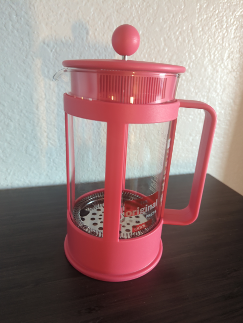 photo of a press pot coffee maker with all the plastic parts in pink