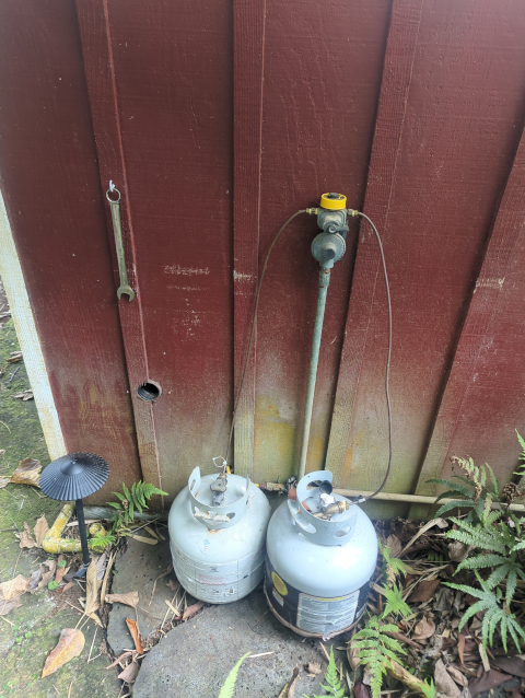 photo of our propane tanks outside of the outdoor shower