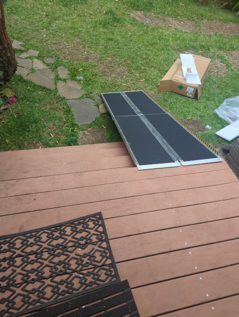 photo of an aluminum wheelchair ramp viewed from atop our front porch