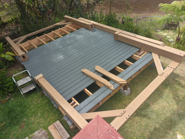 photo of the deck with the posts and short-side beams assembled and ready to be raised into place
