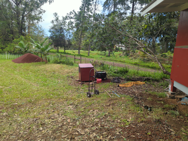 photo from the studio showing the relocated generators and far down in the background a pile of 12 tons of red volcanic cinder