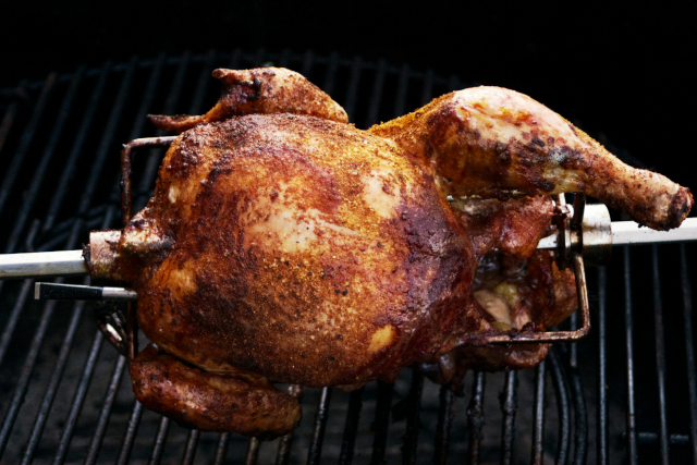 photo of a chicken cooking on a rotisserie