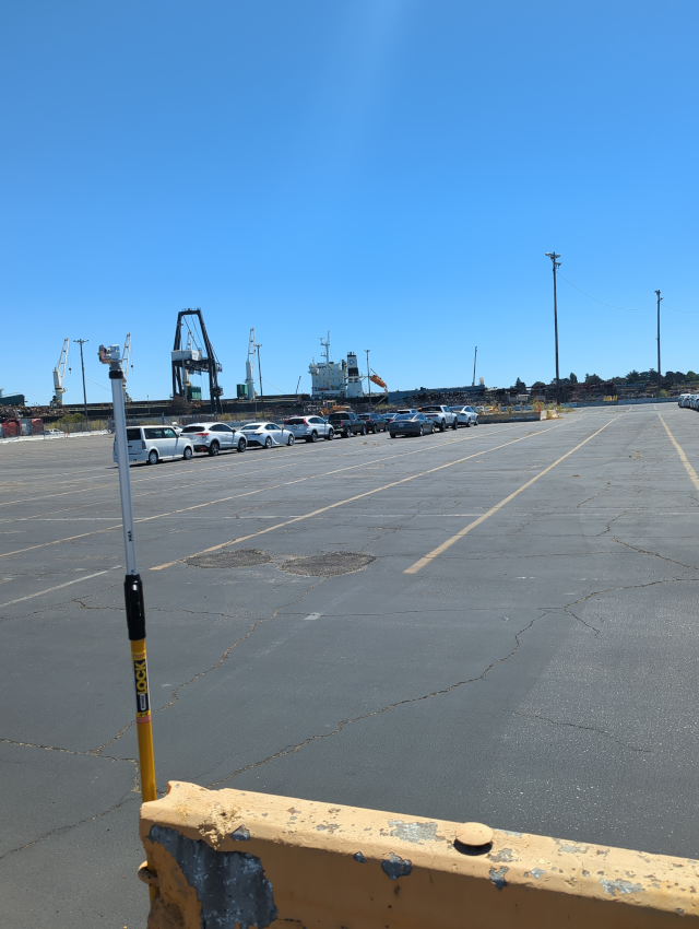 Parking lot at the port showing cars lined up to roll onto the ship