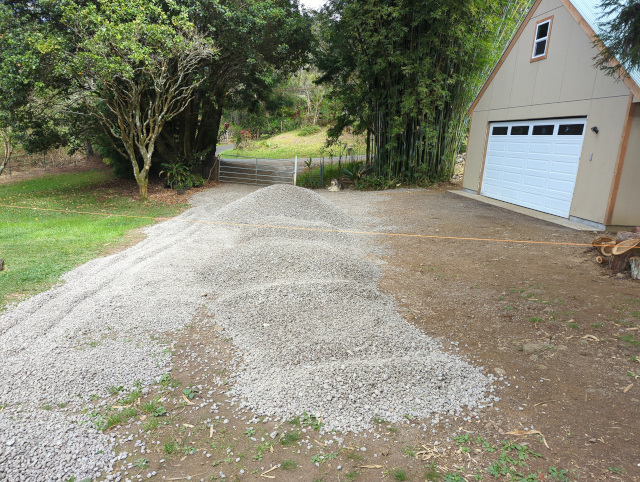 photo of the driveway with a second load of rocks dumped alongside the first